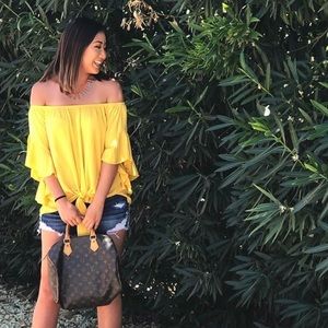 Yellow, off the shoulder shirt with tie